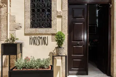 a door to a building with potted plants on it at Harismari Cozy Hotel in Chania Town