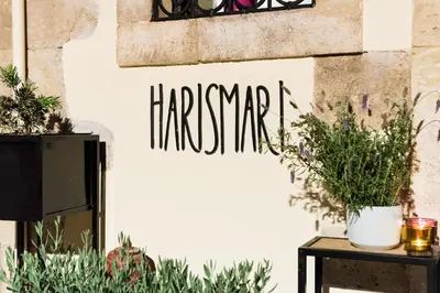 a wall with plants and a sign that reads harerate at Harismari Cozy Hotel in Chania Town
