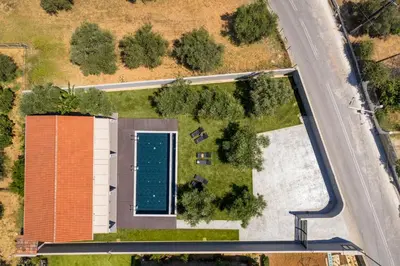 an overhead view of an orange building with a swimming pool at Eightyfour Living with private pool in Chania Town