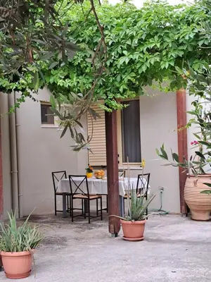 a patio with a table and chairs and plants at Mavrogenis Farm Chania Crete in Plataniás