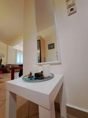 a white table in a room with a mirror at Mavrogenis Farm Chania Crete in Plataniás