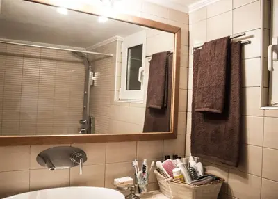 a bathroom with a sink and a mirror at Nelly's House in Chania Town