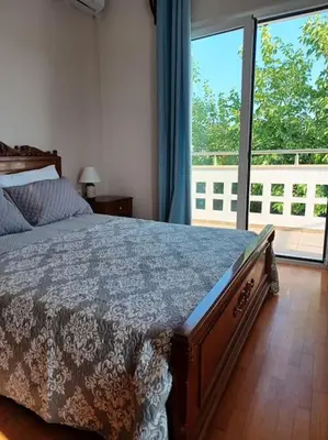 a bedroom with a bed and a large window at Casa Dastele remarkable seaview 5' from the sea in Chania Town