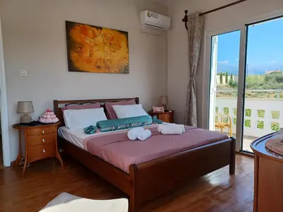 a bedroom with a bed with two stuffed animals on it at Casa Dastele remarkable seaview 5' from the sea in Chania Town