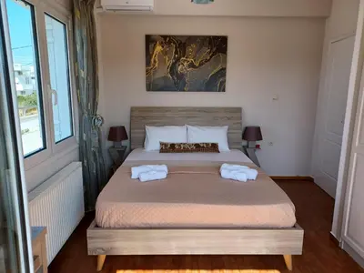 a bedroom with a bed with two towels on it at Casa Dastele remarkable seaview 5' from the sea in Chania Town