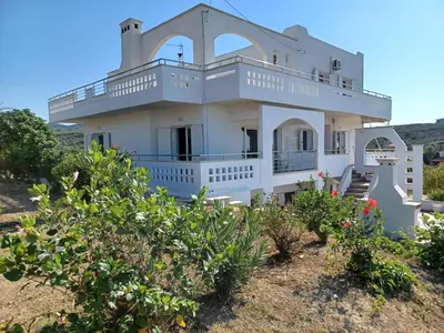 a white house with a balcony on the beach at Casa Dastele remarkable seaview 5' from the sea in Chania Town