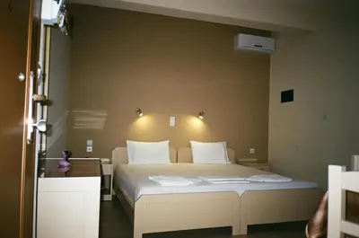 a bedroom with a large bed with white pillows at John Apartments in Plataniás