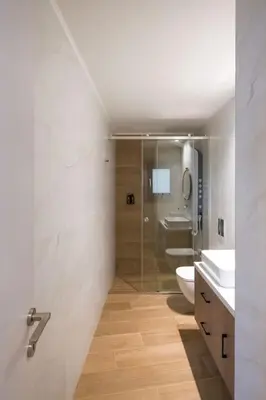 a bathroom with two sinks and a toilet and a shower at In Heart of Old Town Saint Rocco's Chic Apt in Chania Town