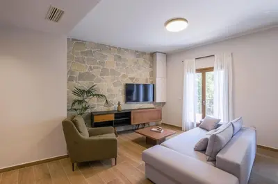 a living room with a couch and a tv at In Heart of Old Town Saint Rocco's Chic Apt in Chania Town