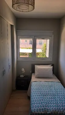 a bedroom with a bed and a window at Elena Apartments in Kato Daratso