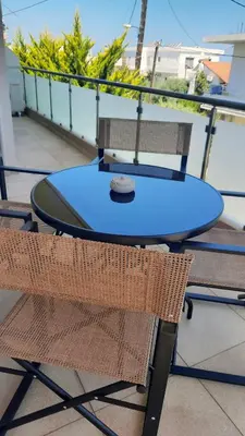 a blue table and chairs on a balcony at Elena Apartments in Kato Daratso