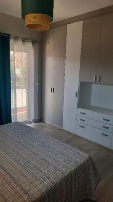 a bedroom with a large bed and a dresser at Elena Apartments in Kato Daratso