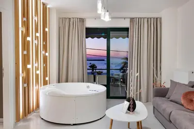 a living room with a tub in the middle of a room at Elia Beach Deluxe Apartment in Chania Town