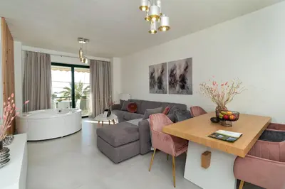 a living room with a couch and a table at Elia Beach Deluxe Apartment in Chania Town