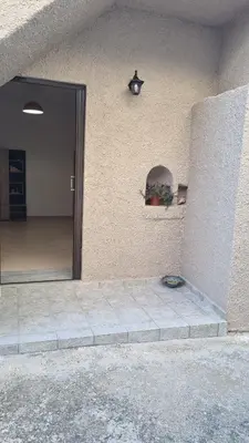 a building with a door open to a patio at Casa Artemis in Plátanos