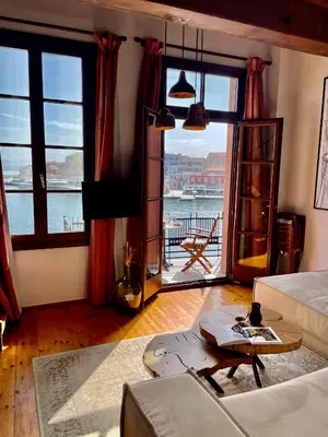 a living room with a view of the water at Erietta Suites in Chania Town