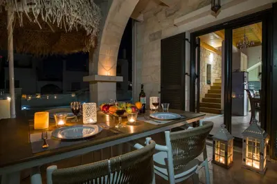 a dining table with chairs and a tableablish at Villa Constancia in Stalos