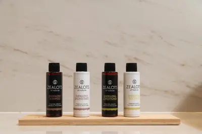 three bottles of hair products sitting on a wooden shelf at The Alma City Suites in Chania Town