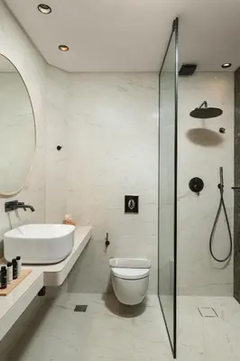 a bathroom with a toilet and a sink and a shower at The Alma City Suites in Chania Town