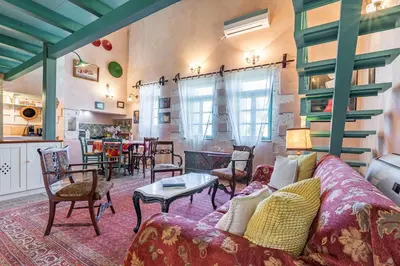 a living room with a couch and a table at Thimari Gardens in Chania Town