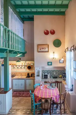 a kitchen and dining room with a table and chairs at Thimari Gardens in Chania Town