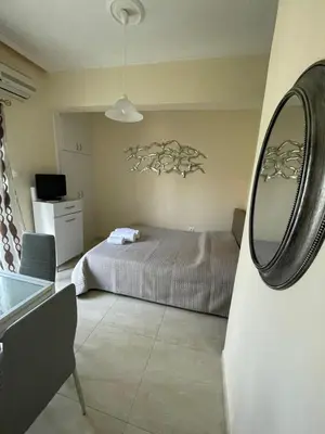 a bedroom with a bed and a mirror at Anastasia City Home in Chania Town