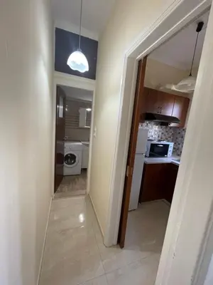 a hallway leading into a kitchen with a door open at Anastasia City Home in Chania Town