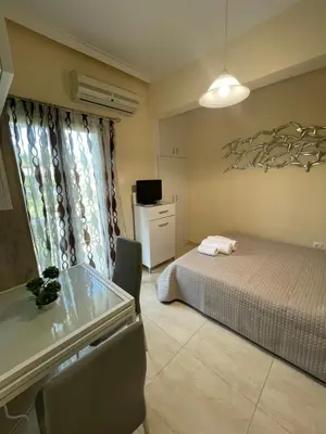 a bedroom with a bed and a table and chairs at Anastasia City Home in Chania Town