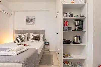 a small bedroom with two beds and shelves at Koum Kapi Studio B1 in Chania Town