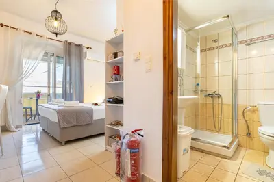 a bathroom with a bed and a shower and a toilet at Koum Kapi Studio B1 in Chania Town