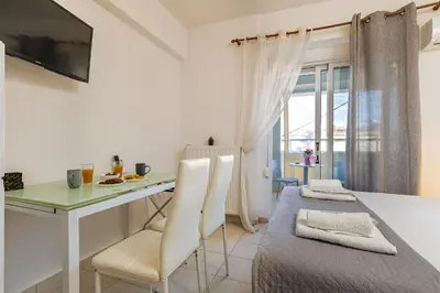 a kitchen and dining room with a table and chairs at Koum Kapi Studio B1 in Chania Town