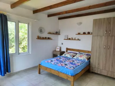 a bedroom with a bed and a wooden cabinet at Vine Veranda in Palaiochóra