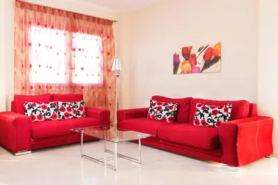 a living room with two red couches and a table at Kronos Villas in Kolymvari