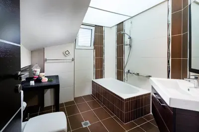 a bathroom with a tub and a sink and a toilet at Kronos Villas in Kolymvari