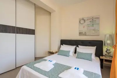 a bedroom with a bed with two pillows on it at AnnaBoutique Villa Next to Beach Private Pool & BBQ in Kato Daratso