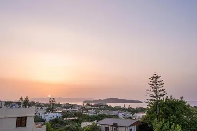 a view of a city at sunset at AnnaBoutique Villa Next to Beach Private Pool & BBQ in Kato Daratso