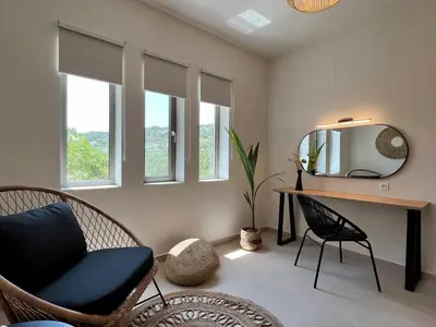 a room with a desk and a mirror and chairs at Villa Karissa in Gavalochori