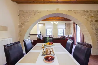 a dining room with a table and chairs at Villas Kalives in Kalyves