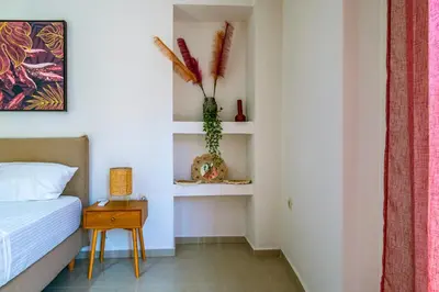 a bedroom with a bed and a table and shelves at Lazareta 3 in Chania Town