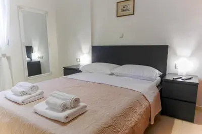 a bedroom with a large bed with towels on it at Dictamus apartment in Chania Town