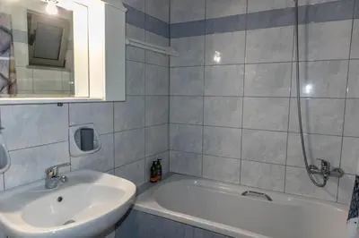 a bathroom with a sink and a bath tub at Dictamus apartment in Chania Town