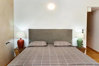 a bedroom with a large bed with two lamps at Luminous a House of Luxury in Chania Town