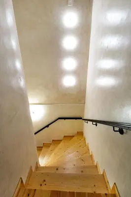 a staircase in a room with wooden floors and lights at Luminous a House of Luxury in Chania Town