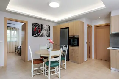 a kitchen and dining room with a table and chairs at Argiros House in Chania Town