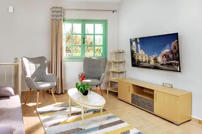 a living room with a tv on a wall at Argiros House in Chania Town