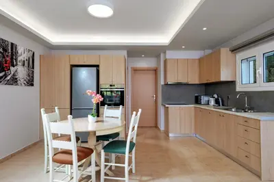 a kitchen and dining room with a table and chairs at Argiros House in Chania Town