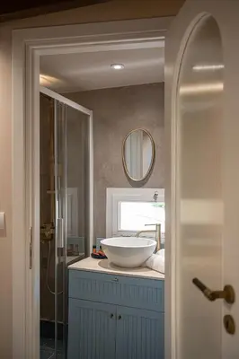 a bathroom with a sink and a mirror at Artemide city places _Leon tiny suite in Chania Town