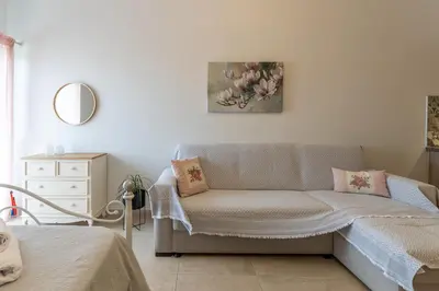 a living room with a couch and a painting on the wall at Kaiti 's Studios & Apartments in Palaiochóra