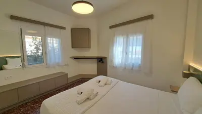 a bedroom with a bed with two towels on it at Downtown Delight in Chania Town