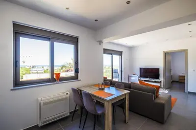 a living room with a table and a couch at Kayzo Luxury Apartment With Pool in Tavronitis